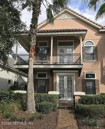 a view of a brick house with large windows