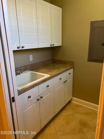 a view of a storage and utility room with cabinets