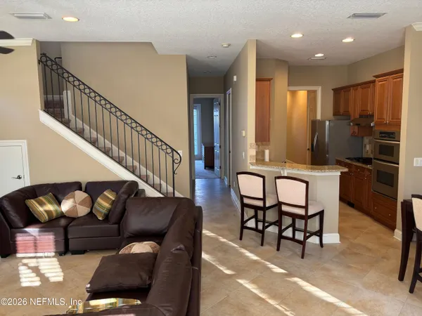 a living room with furniture and stairs