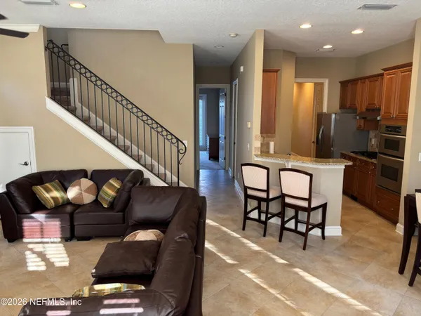 a living room with furniture and wooden floor