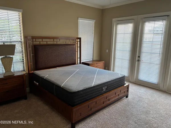 a bed sitting in a bedroom next to a window