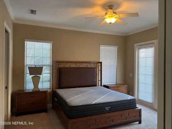 a bedroom with a bed and window