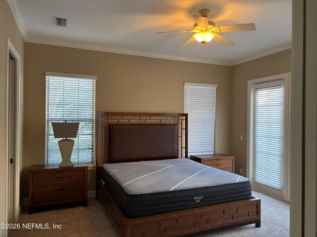 a bedroom with a bed and window