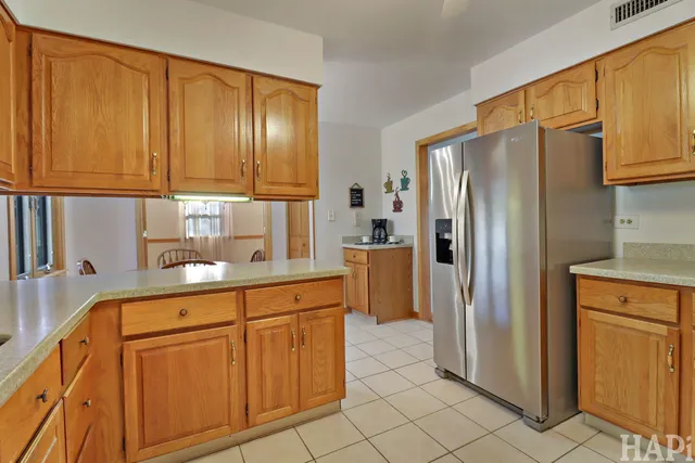 a kitchen with stainless steel appliances granite countertop a refrigerator and cabinets