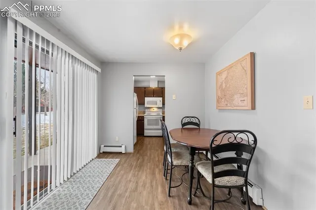 a view of a dining room with furniture and a window