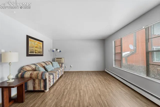 a living room with furniture and a floor to ceiling window