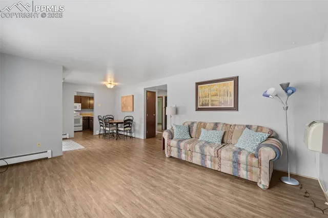a dining room with furniture and wooden floor