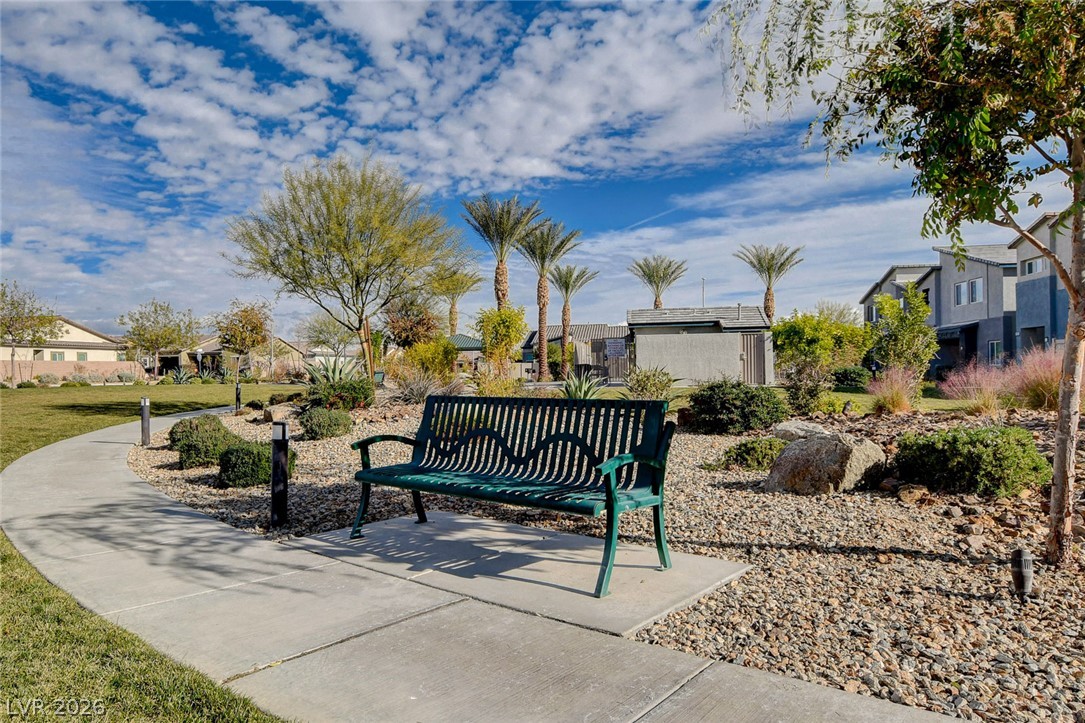 7330 North Decatur Boulevard, Unit 6 North Las Vegas, NV 89084 - Photo 29 of 42 A tranquil park path winds through a xeriscaped landscape, offering a serene outdoor retreat.