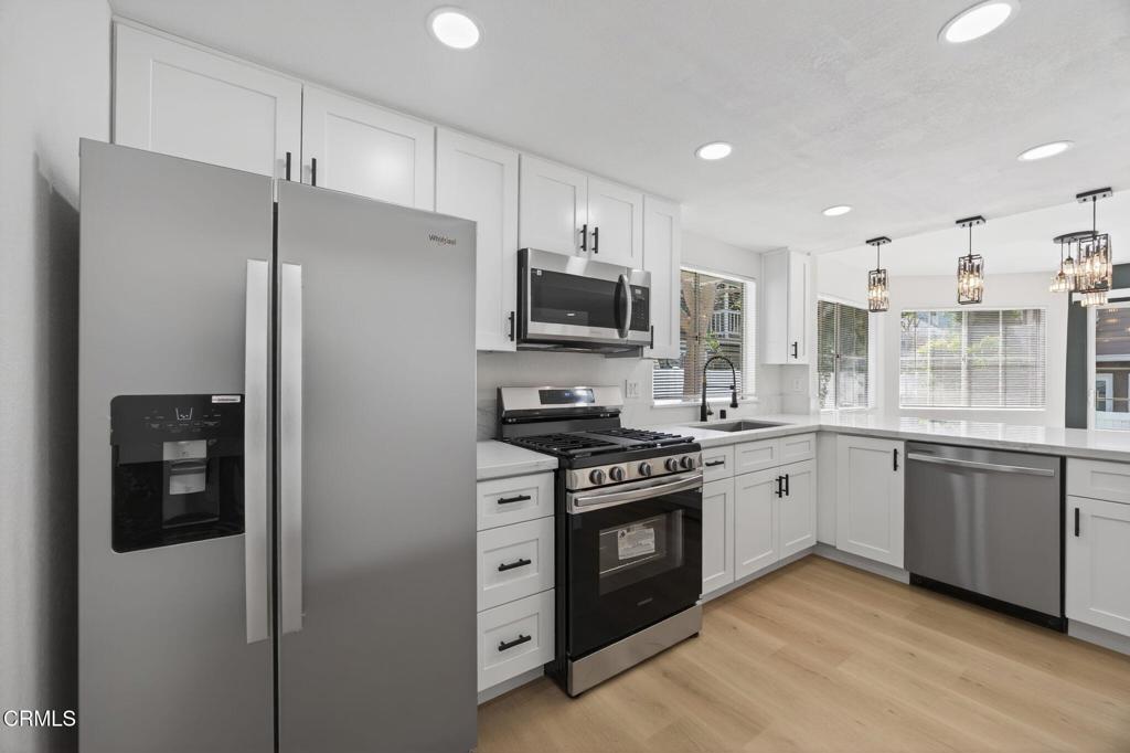 1948 Rory Lane, Unit 5 Simi Valley, CA 93063 - Photo 11 of 25 a kitchen with stainless steel appliances granite countertop a stove a refrigerator and a sink