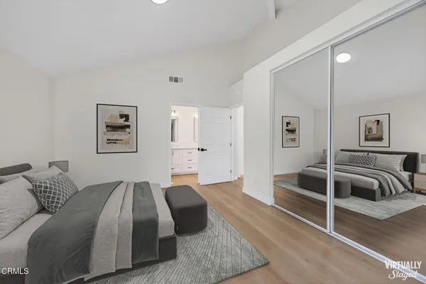 a spacious bedroom with a bed and couch