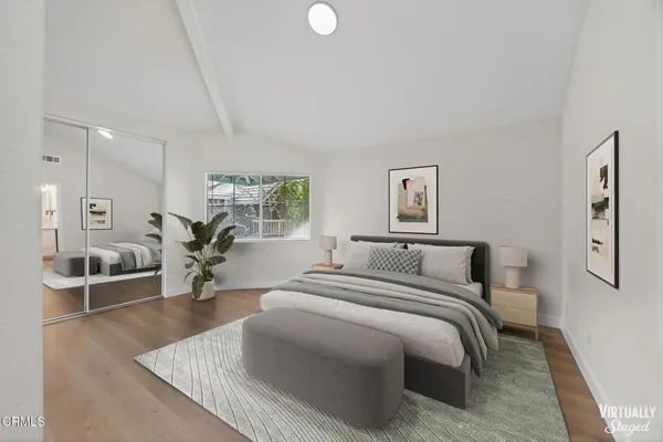 a bedroom with a bed and couch