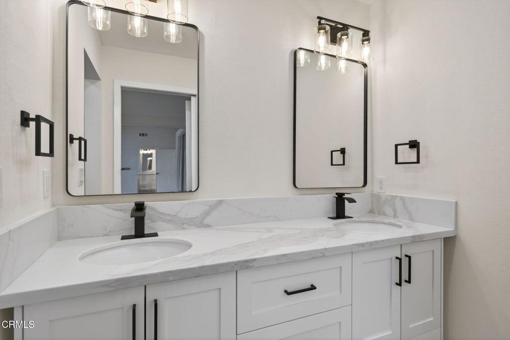 1948 Rory Lane, Unit 5 Simi Valley, CA 93063 - Photo 16 of 25 a bathroom with double vanity sinks and a mirror
