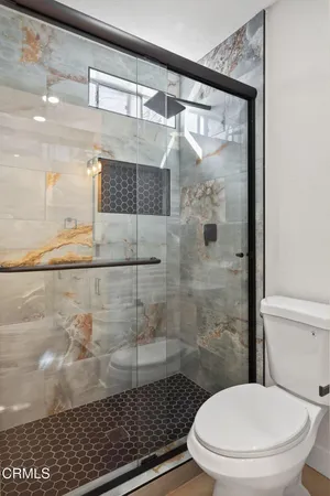 a bathroom with a toilet and a shower