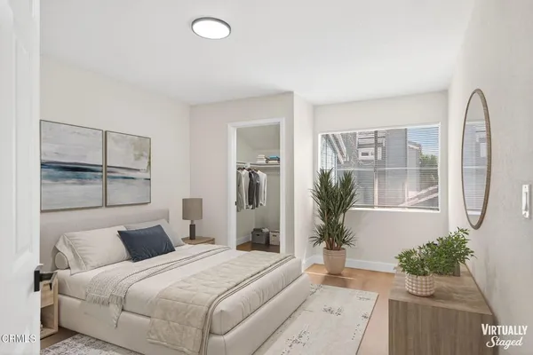 a bedroom with bed and wooden floor