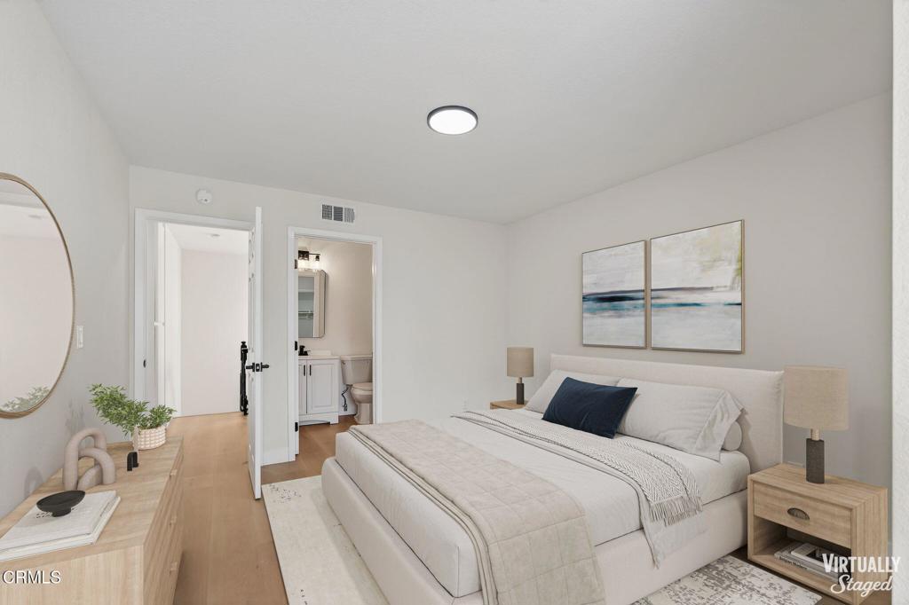 1948 Rory Lane, Unit 5 Simi Valley, CA 93063 - Photo 19 of 25 a bedroom with a bed and a chandelier