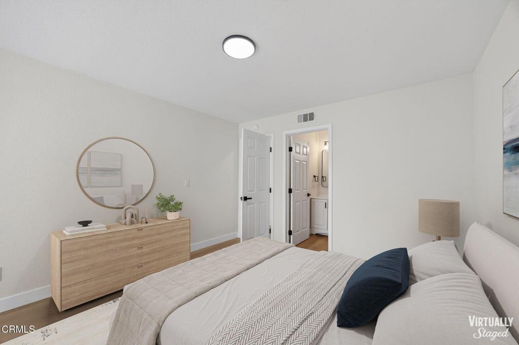 1948 Rory Lane, Unit 5 Simi Valley, CA 93063 - Photo 20 of 25 a bedroom with a bed and a mirror