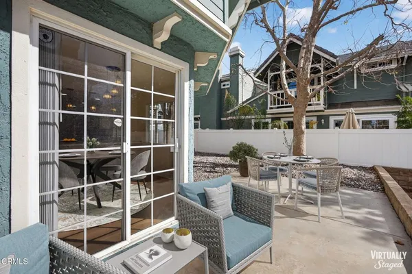a view of a patio with couches and potted plants