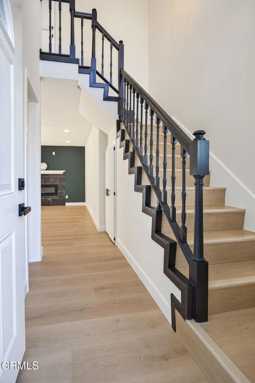 1948 Rory Lane, Unit 5 Simi Valley, CA 93063 - Photo 4 of 25 a view of staircase with lots of frames on wall and a potted plant