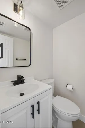 a bathroom with a sink toilet and mirror