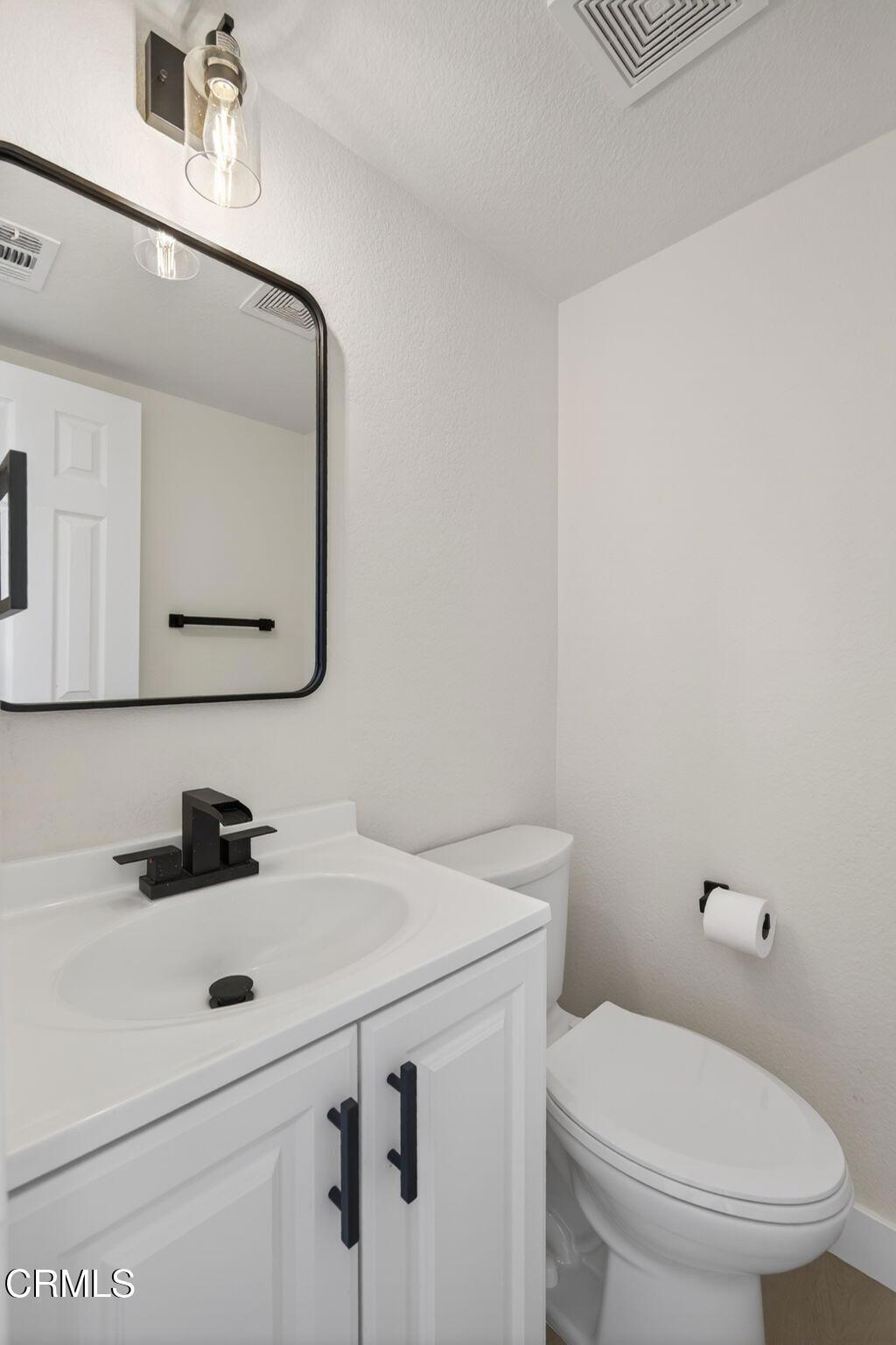 1948 Rory Lane, Unit 5 Simi Valley, CA 93063 - Photo 5 of 25 a bathroom with a sink toilet and mirror