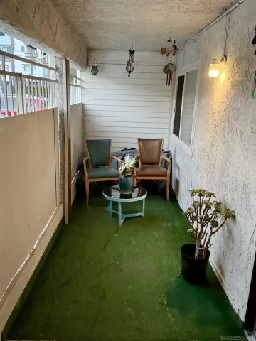 a view of a porch with furniture and a yard