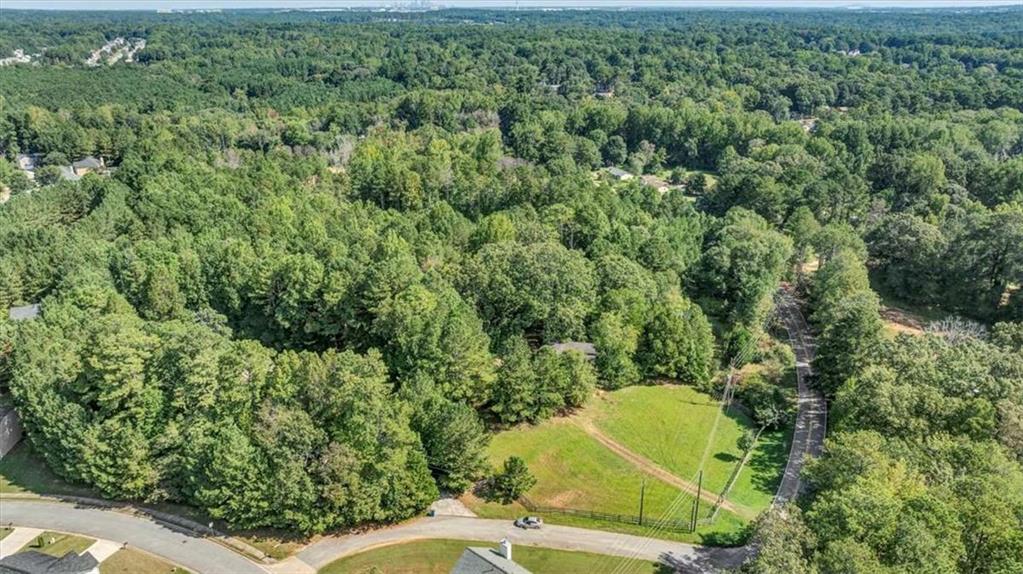 6765 Dagenhart Road Atlanta, GA 30349 - Photo 23 of 27 an aerial view of a residential houses with yard and trees in the background