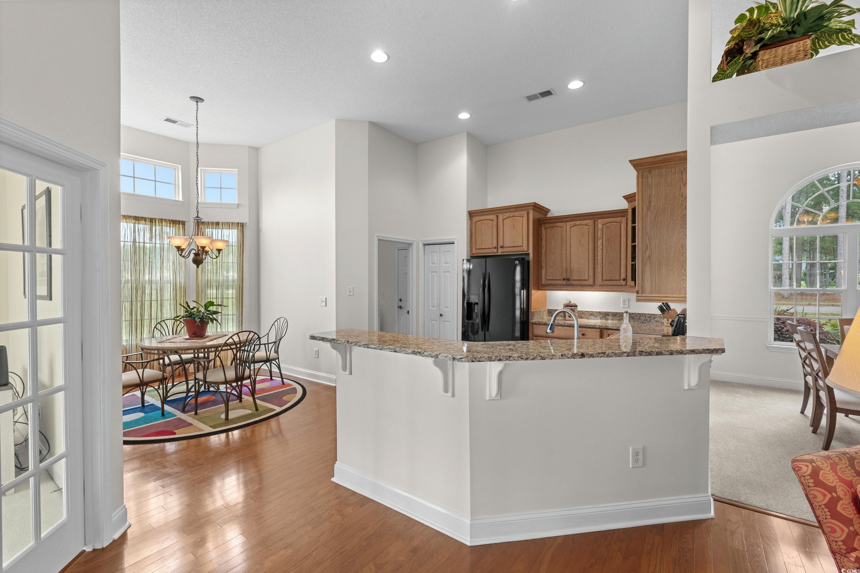 5025 Westwind Drive Myrtle Beach, SC 29579 - Photo 14 of 36 Kitchen with stone counters, a towering ceiling, v