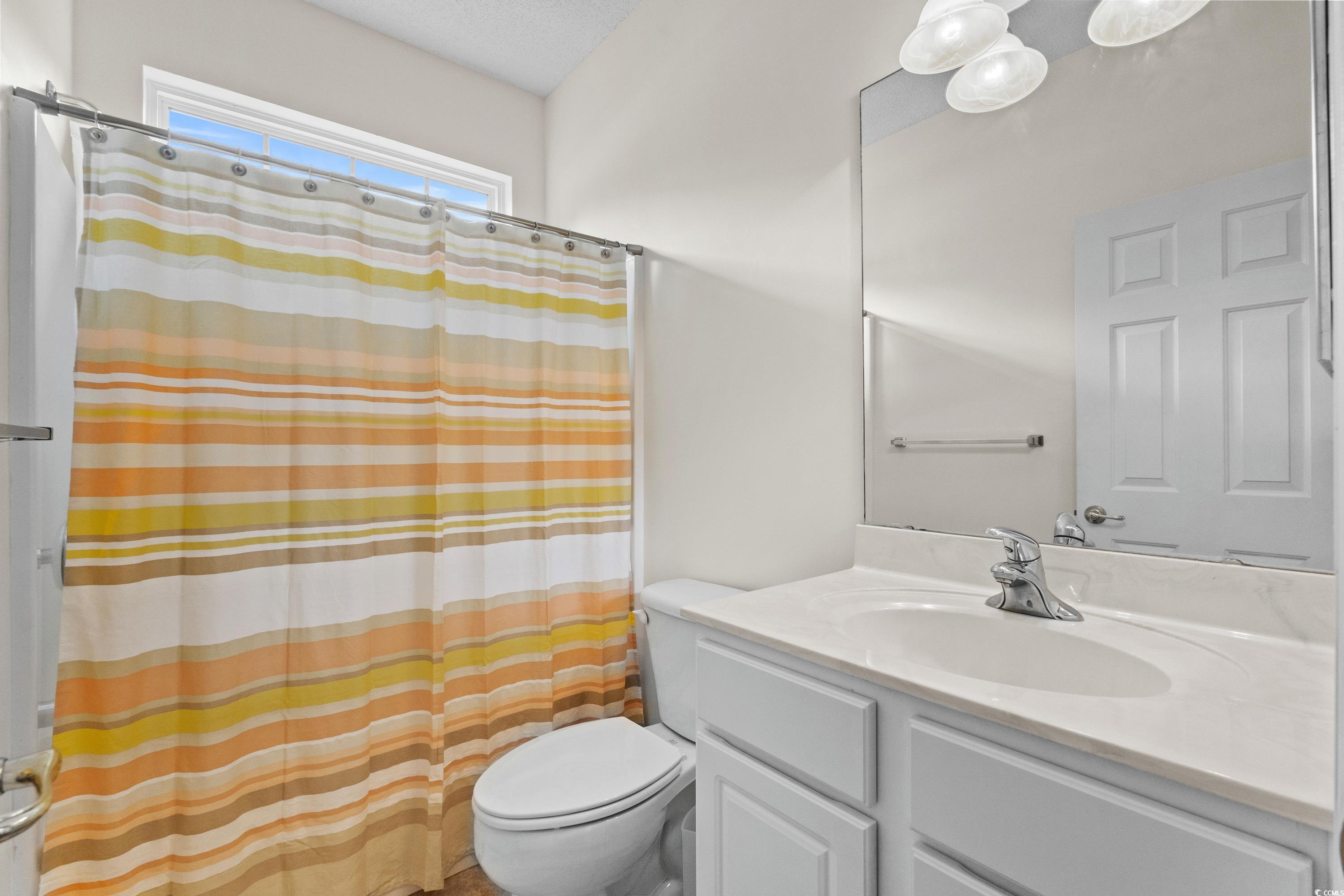 5025 Westwind Drive Myrtle Beach, SC 29579 - Photo 35 of 36 Full bathroom with curtained shower, vanity, and t