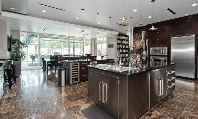a bathroom with a granite countertop sink a mirror and shower