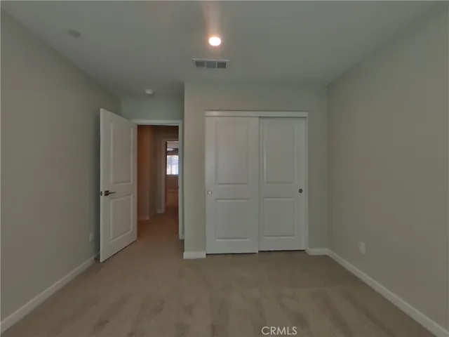an empty room with closet area