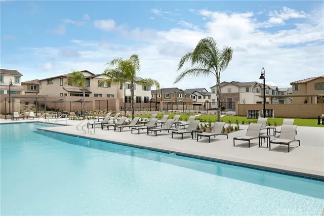 a view of swimming pool with outdoor seating and plants