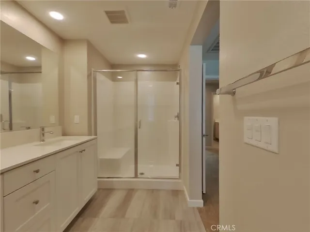 a bathroom with a shower sink and mirror