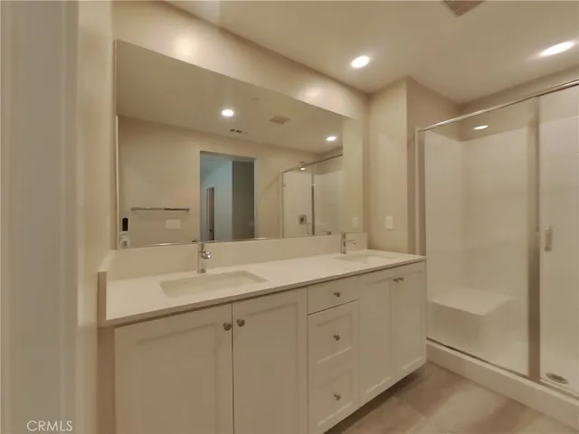 a bathroom with a sink a toilet a shower and a mirror