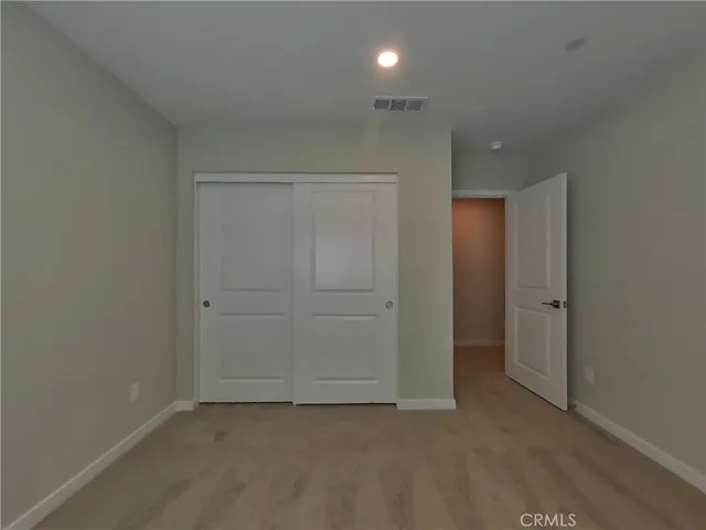 an empty room with closet area