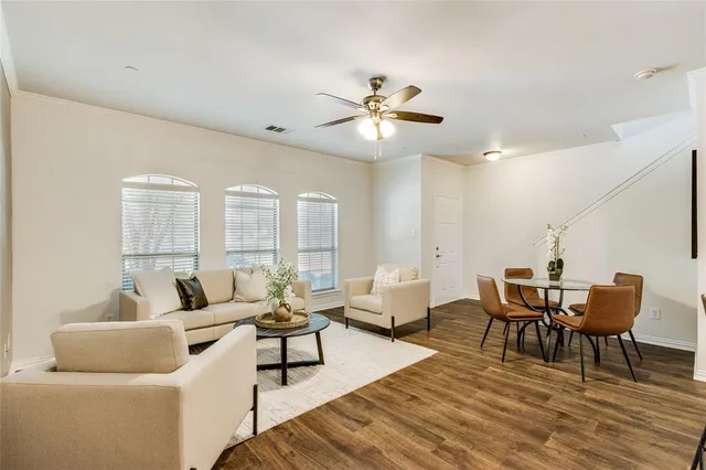 a living room with furniture wooden floor and a table