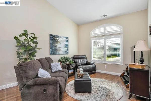 a living room with furniture windows and a table