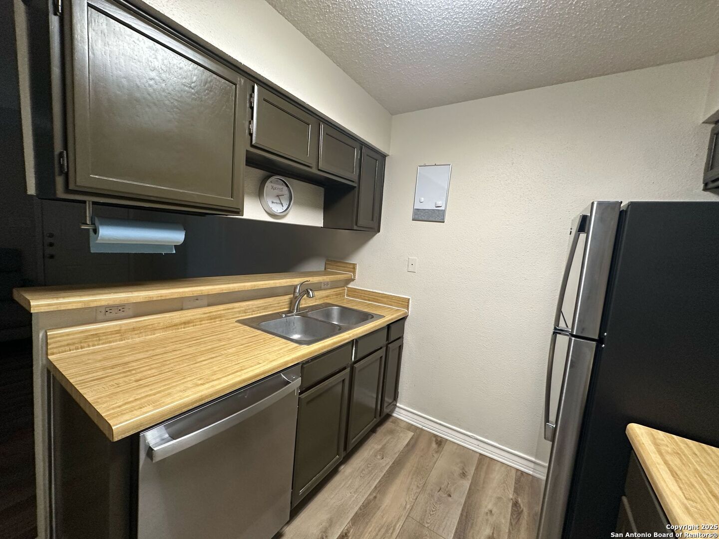 4949 Hamilton Wolfe Road, Unit 8201 San Antonio, TX 78229 - Photo 6 of 16 a kitchen with a sink and a refrigerator