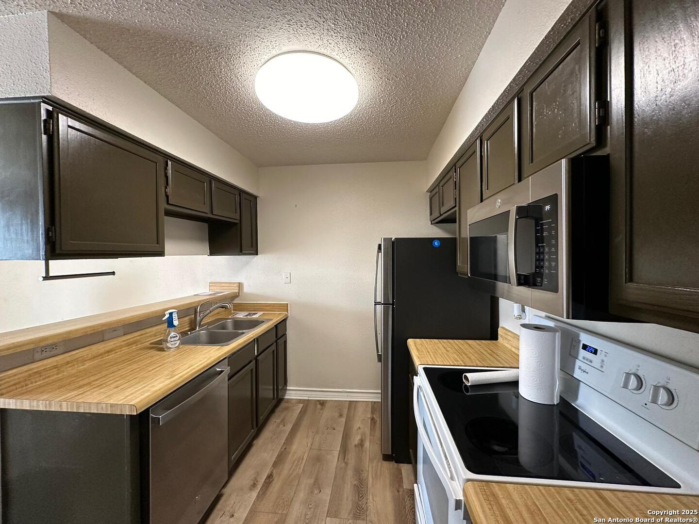 4949 Hamilton Wolfe Road, Unit 8201 San Antonio, TX 78229 - Photo 7 of 16 a kitchen with stainless steel appliances granite countertop a sink stove and refrigerator