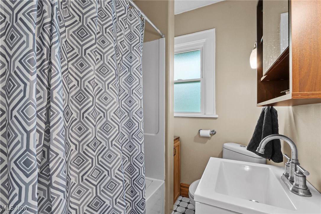 640 Plainfield Road Akron, OH 44312 - Photo 14 of 25 Full bathroom with vanity, shower / bath combo, and tile patterned floors