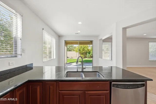 a kitchen with a sink a counter top space and cabinets