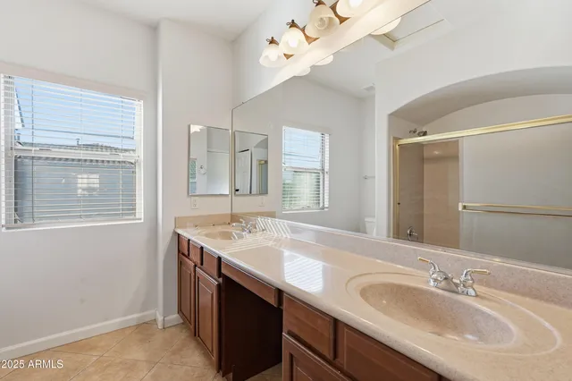 a bathroom with a sink double vanity and a mirror