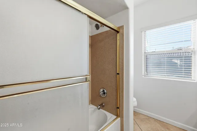 a bathroom with a shower and a tub