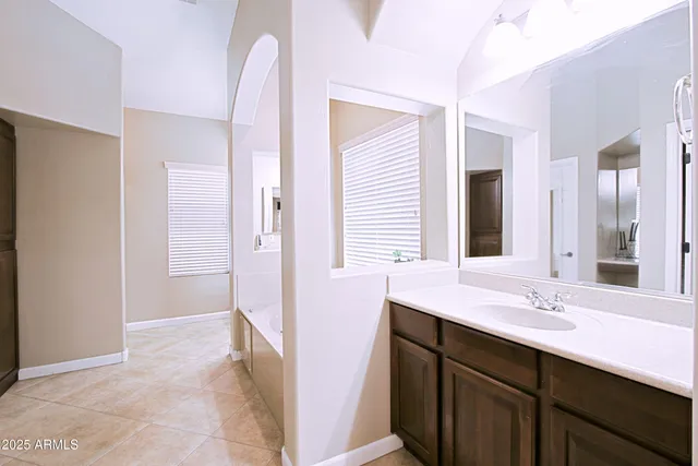 a bathroom with a sink a vanity and a mirror