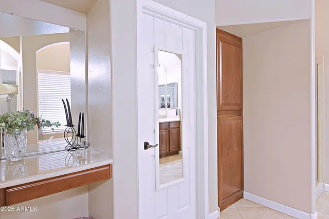a bathroom with a sink a potted plant and a mirror