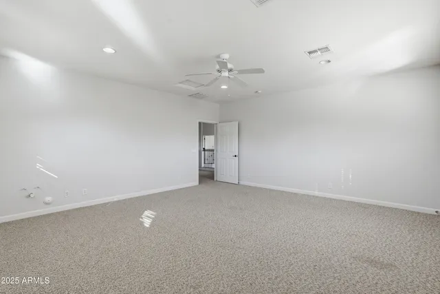 an empty room with a ceiling fan and a ceiling fan