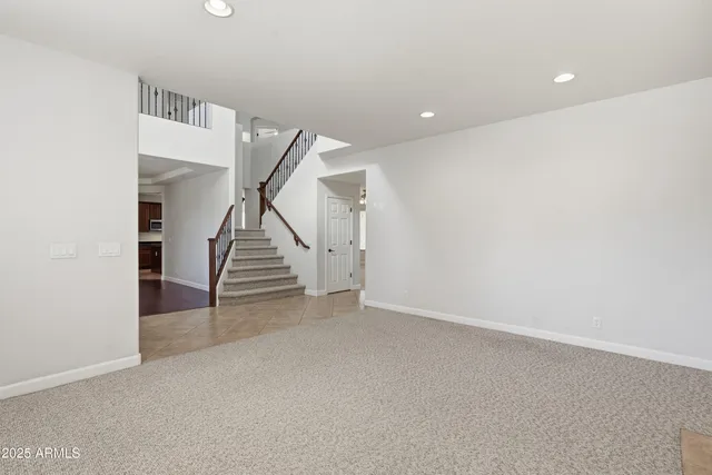 a view of an empty room with stairs