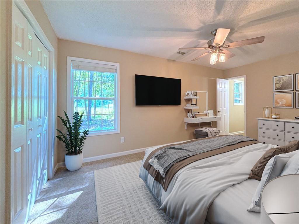 413 Old Brock Road Rockmart, GA 30153 - Photo 14 of 27 a bedroom with a large bed and a flat tv screen