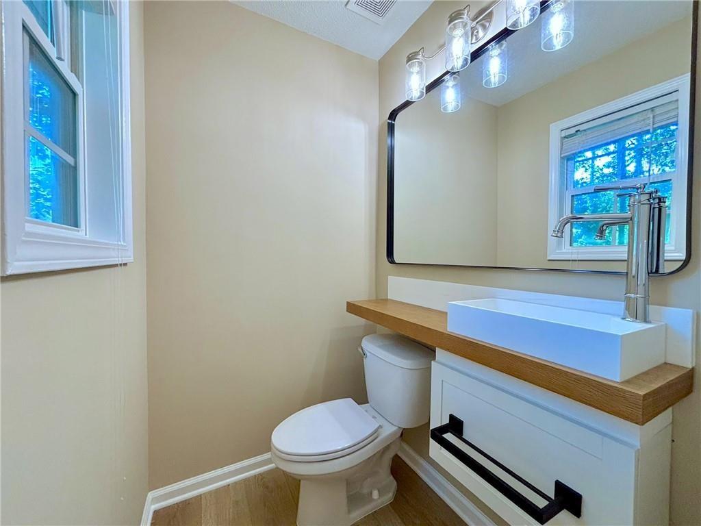 413 Old Brock Road Rockmart, GA 30153 - Photo 17 of 27 a bathroom with a sink mirror and toilet