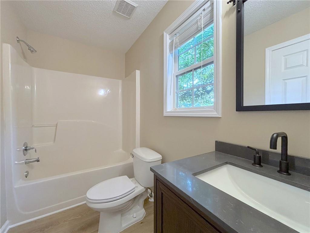 413 Old Brock Road Rockmart, GA 30153 - Photo 21 of 27 a bathroom with a sink toilet a mirror and shower