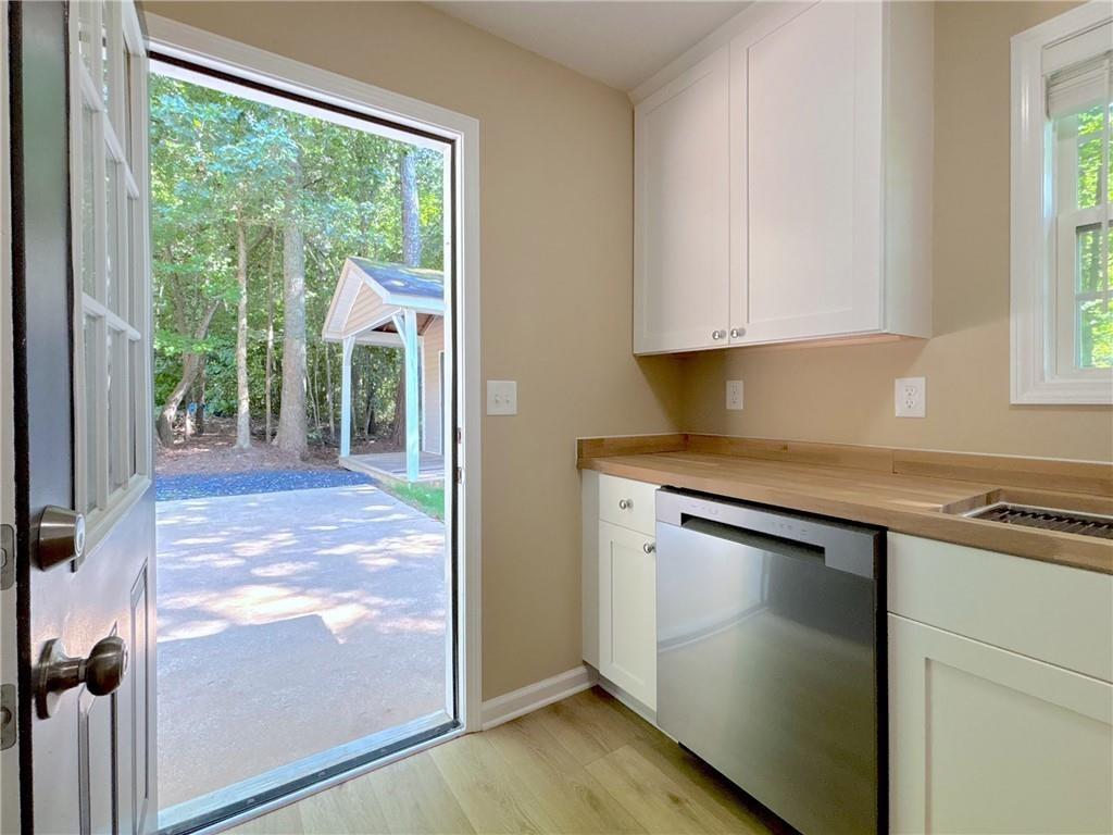 413 Old Brock Road Rockmart, GA 30153 - Photo 22 of 27 a kitchen with granite countertop white cabinets and a window
